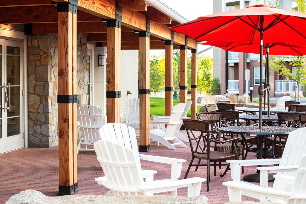 a covered patio with tables and chairs and umbrellas