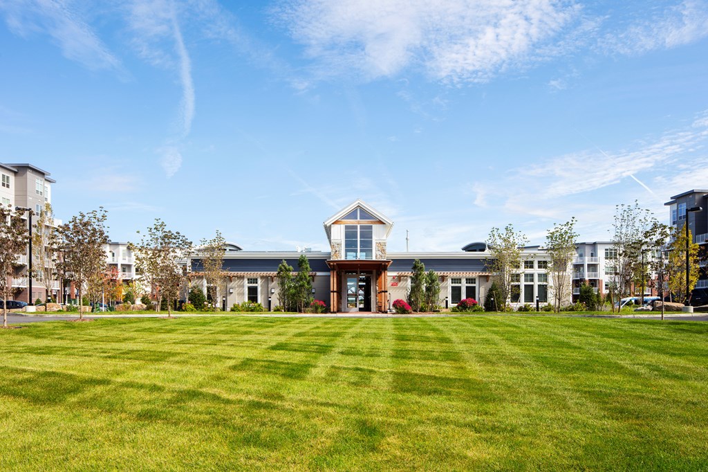 a large building with a lawn in front of it