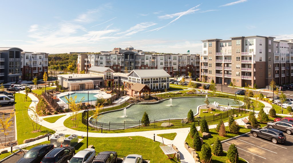 an aerial view of a park with a pool and buildings