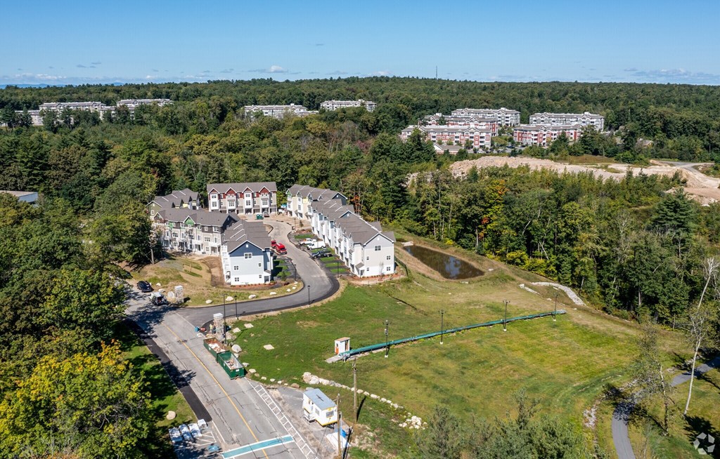 A bird's eye view of a residential area with houses and a road.