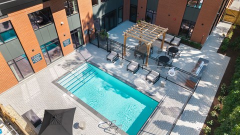 A small pool surrounded by a table and chairs.