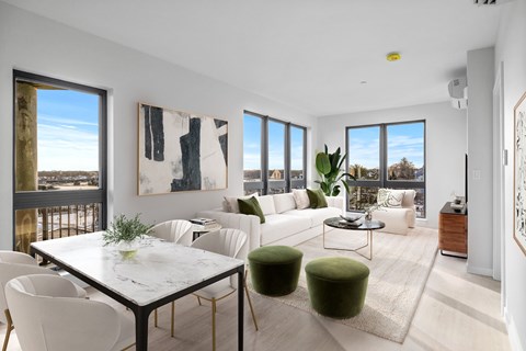 A modern living room with a white dining table and white chairs.