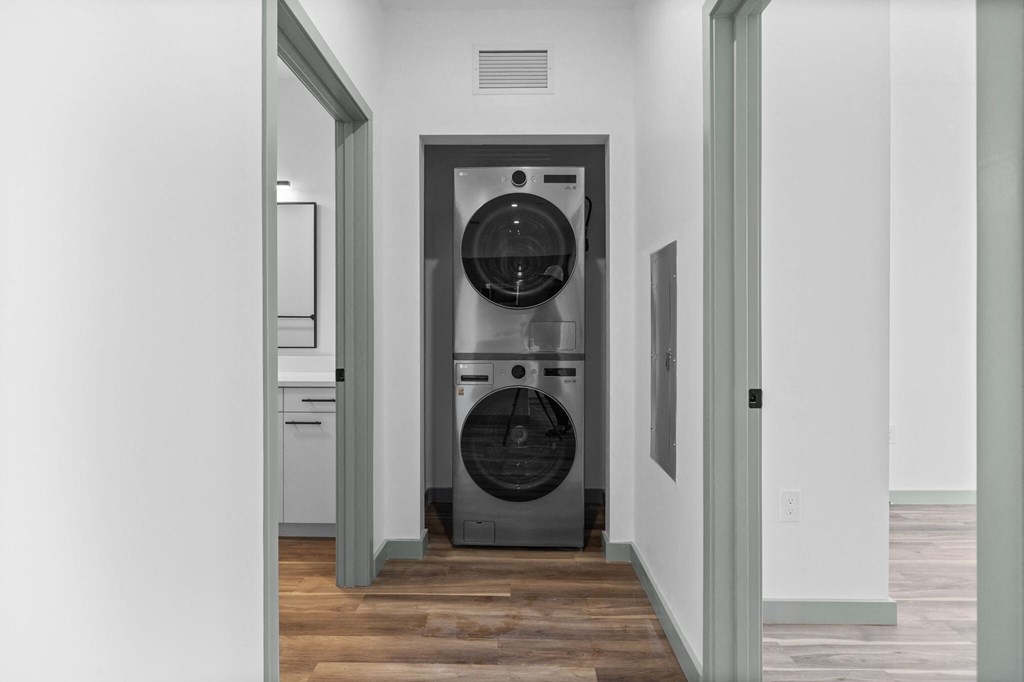 A washer and dryer stacked on top of each other in a laundry room.