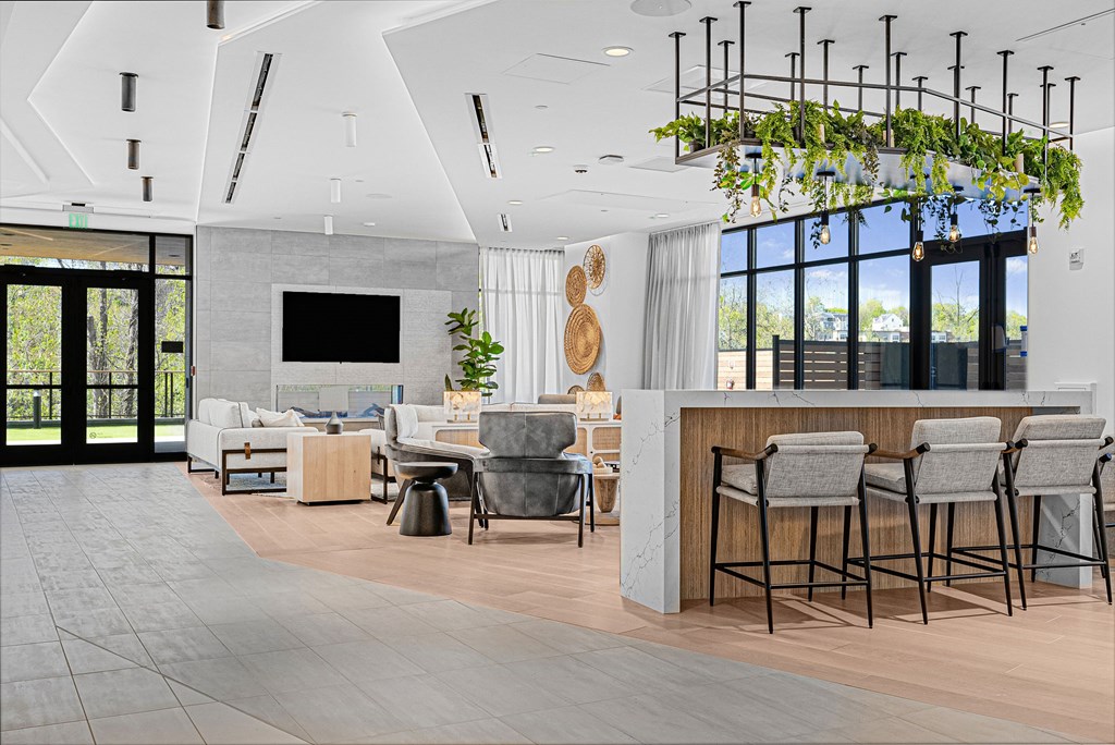 A modern living room with a bar area and a television.