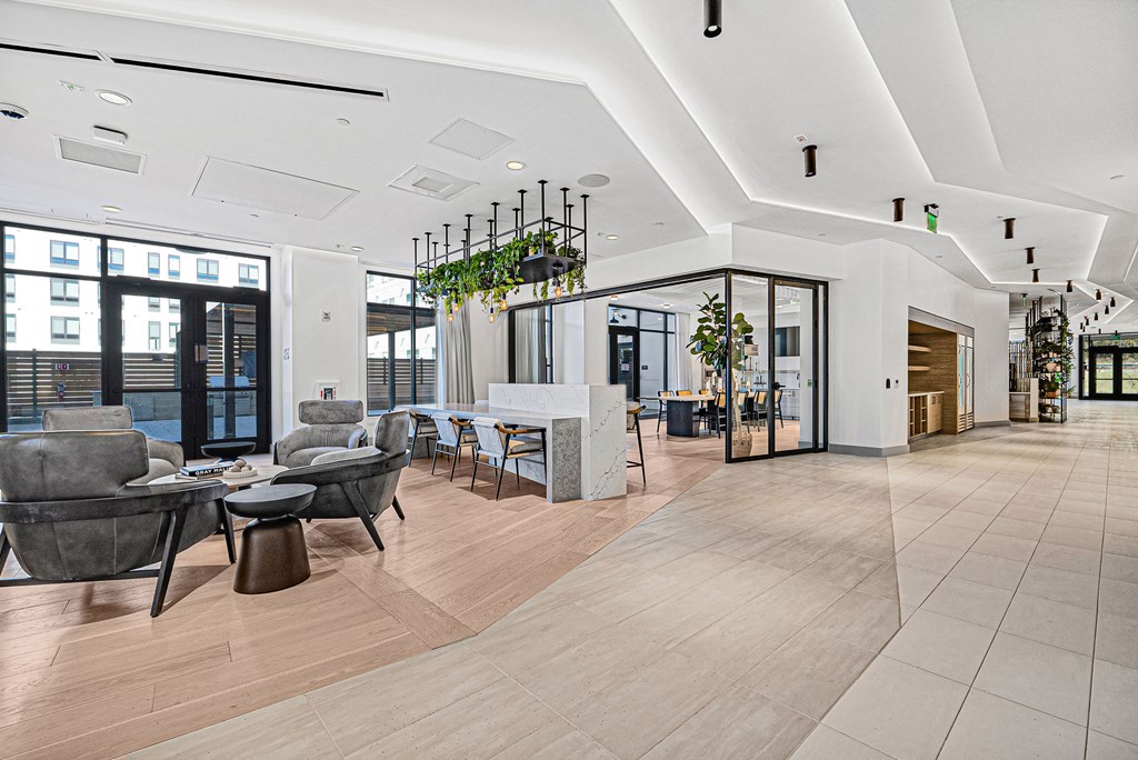 A modern interior with a long hallway and seating area.