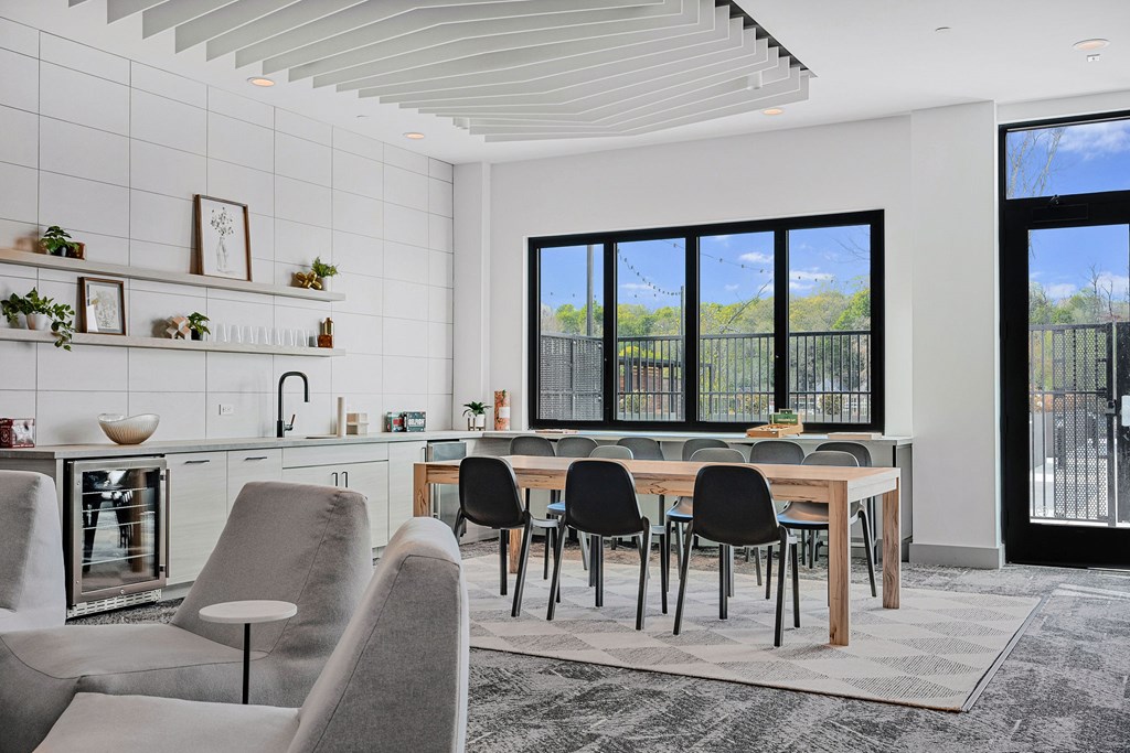 A modern kitchen with a dining table and chairs.