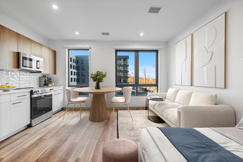 A modern kitchen with a dining table and chairs.