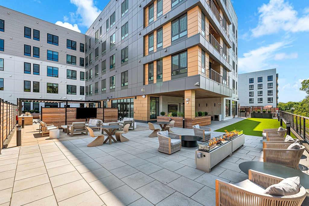 A modern building with a spacious outdoor seating area.