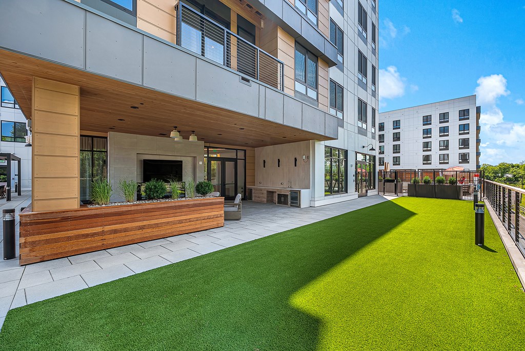 A modern building with a green lawn in front.