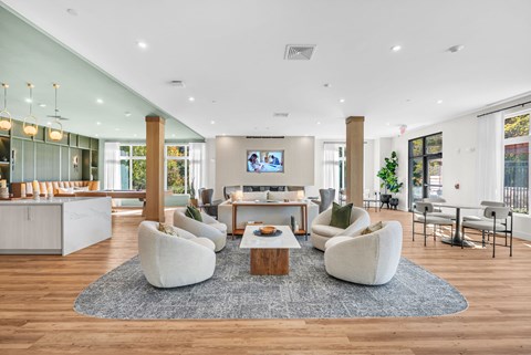 A modern living room with a white sofa set and a television.