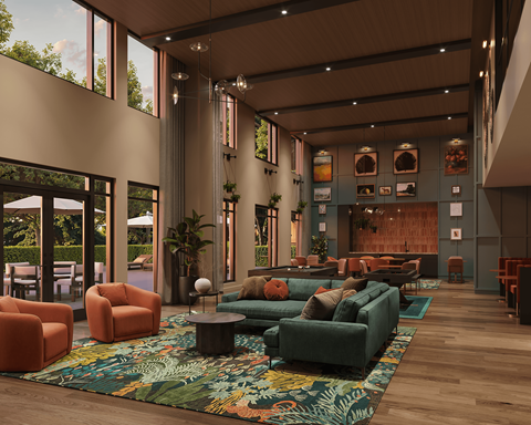 A modern living room with a large rug and a long couch.