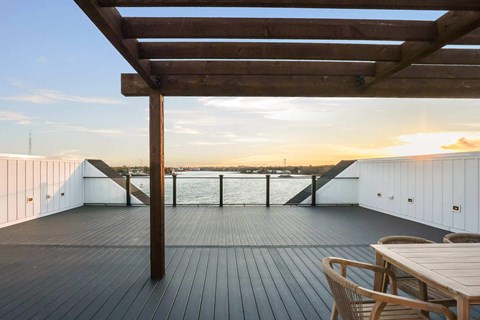 the deck has a view of the water and the sunset