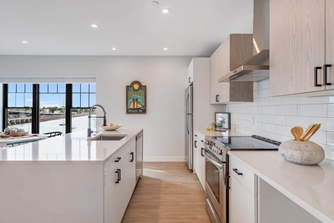 a kitchen with an island and a stove and a window