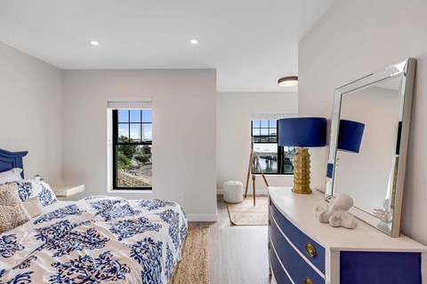 a bedroom with a bed and a mirror