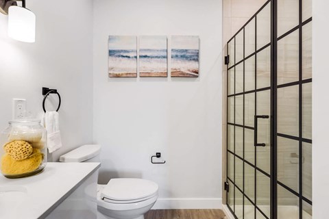 a bathroom with a toilet and a glass shower