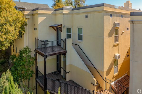 A building with a balcony and stairs.