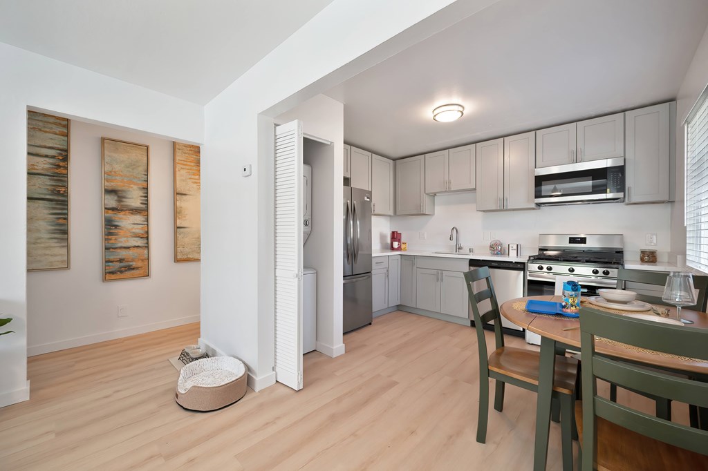 A kitchen with a table and chairs in it.
