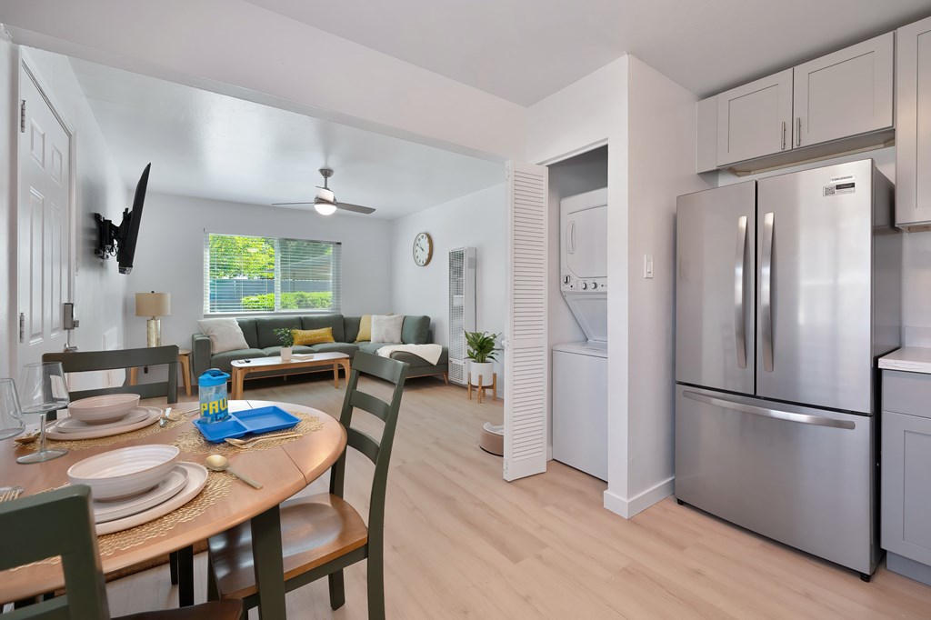A modern kitchen with a dining table set for two.
