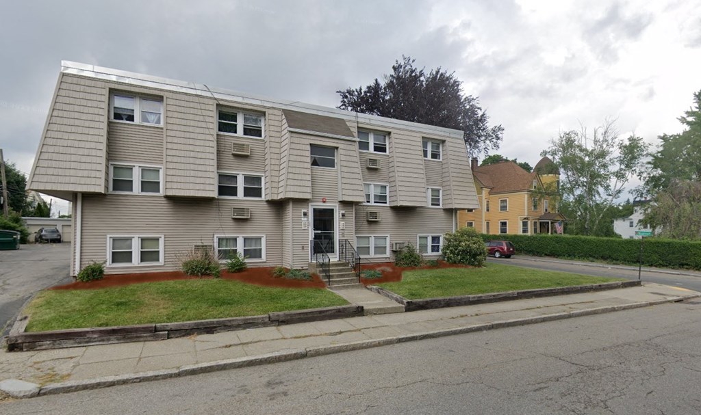 an apartment building on the corner of a street