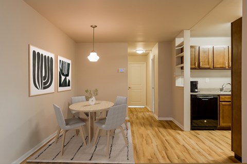 A dining room with a table and chairs.