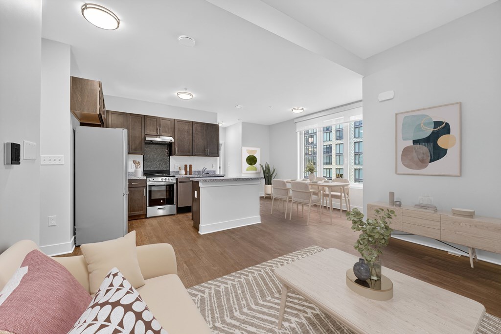 A living room with a couch, a coffee table, and a painting on the wall.