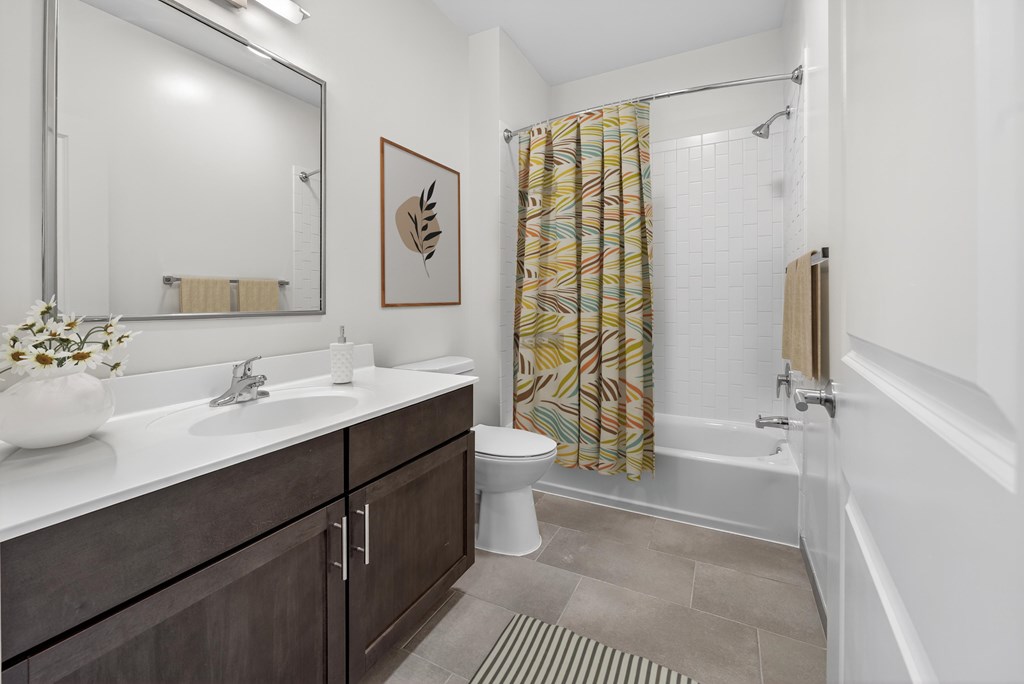 A bathroom with a white sink and a white toilet.