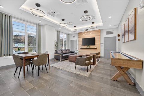 A modern living room with a pool table and a television.