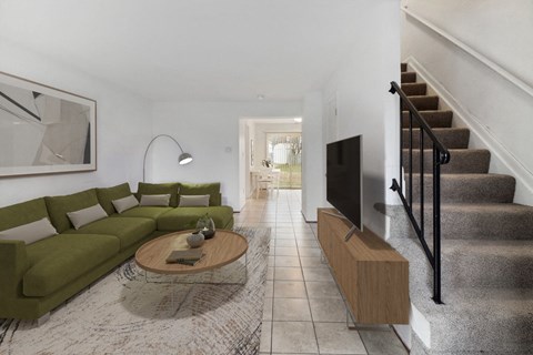 A living room with a green couch and a coffee table.