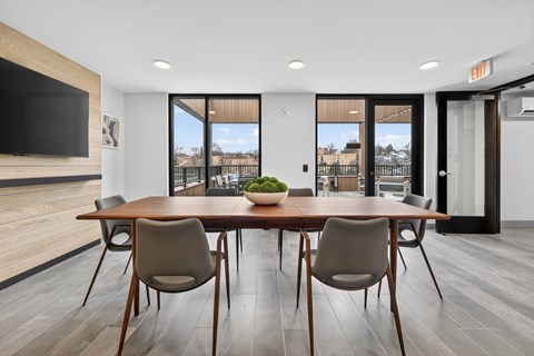 A modern dining room with a wooden table and chairs.