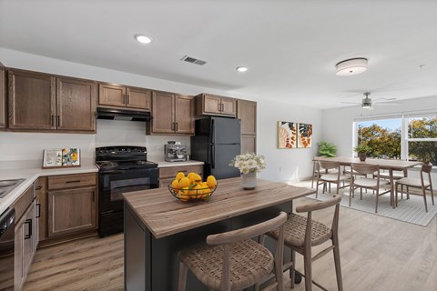 A kitchen with wooden cabinets and a black refrigerator.