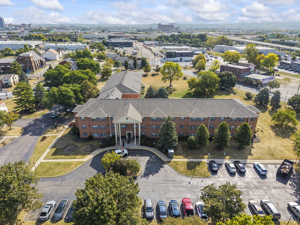 A large building with a parking lot in front of it.