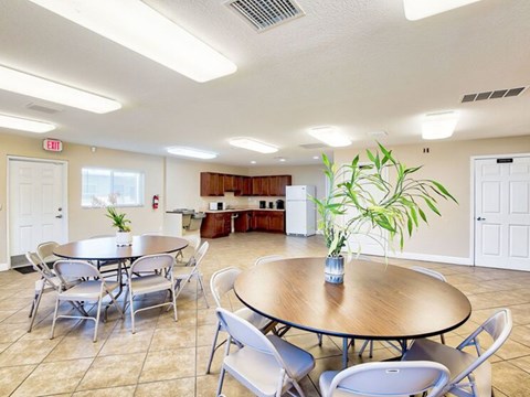 A dining room with a round table and chairs.