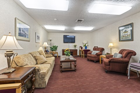 A living room with a couch, chairs, and a coffee table.