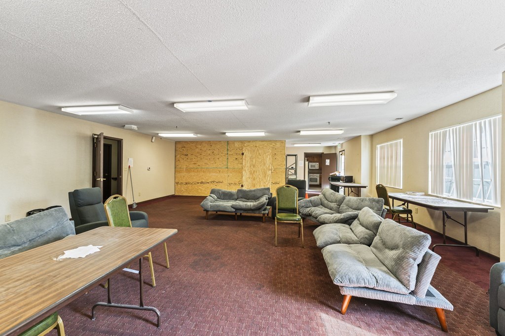 A conference room with a long table and chairs.