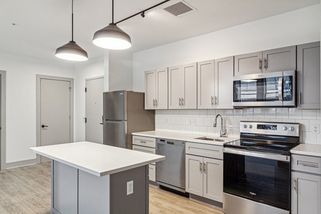 a kitchen with stainless steel appliances and white cabinets