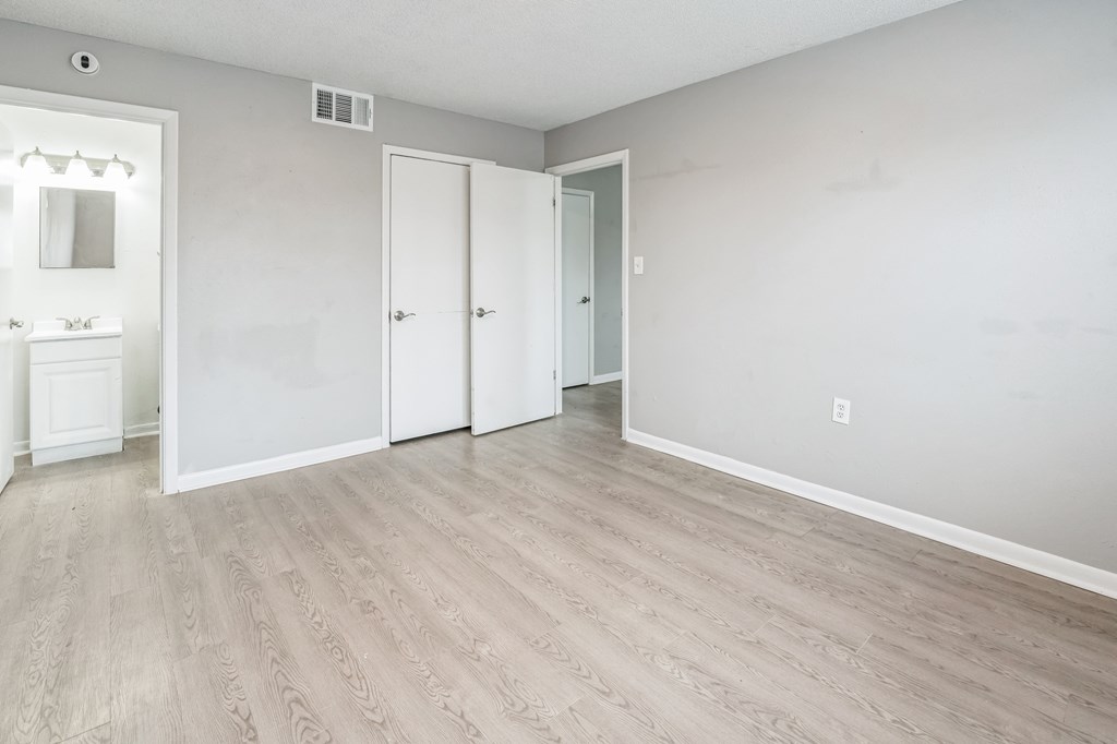 A room with a white door and a white sink.