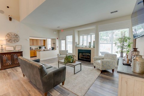 A living room with a grey couch and a fireplace.