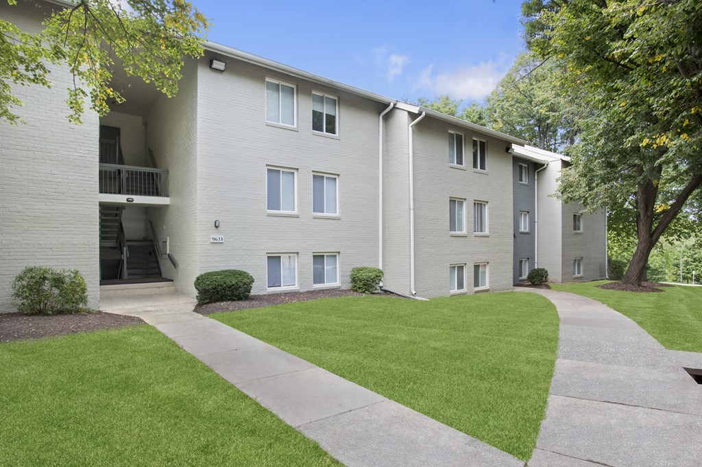 Apartment building with a green lawn in front.