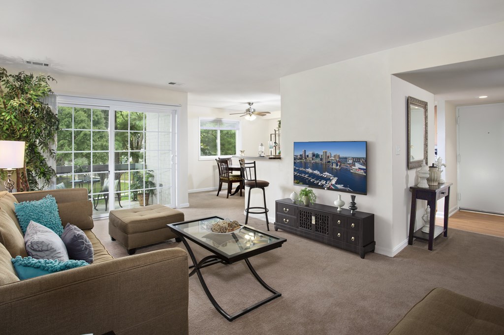 A living room with a couch, a coffee table, and a painting on the wall.