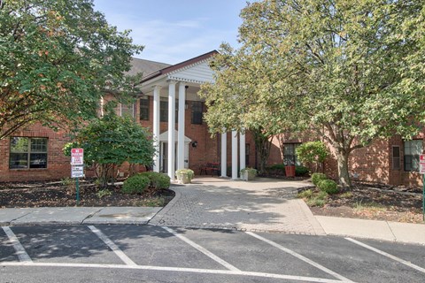 A building with a red brick facade and a white columned entrance.