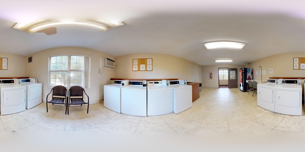 A bank with a white counter and two chairs.