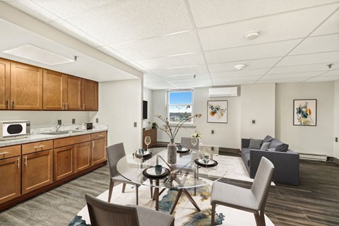 a living room and kitchen with a table and chairs