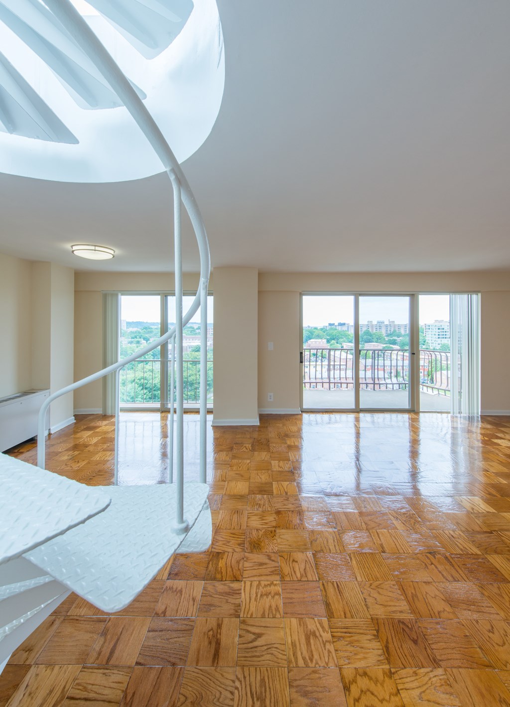 A spiral staircase in a room with wooden floors.