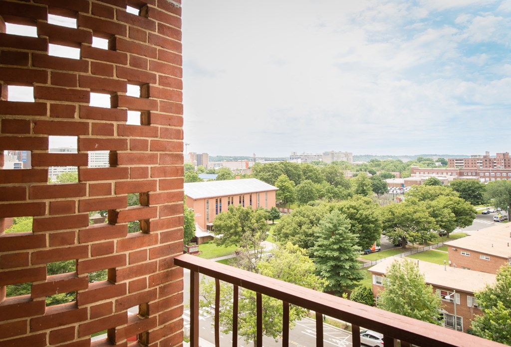 A view from a balcony looking out over a residential area.