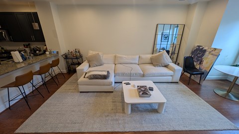 A living room with a white couch and a coffee table.