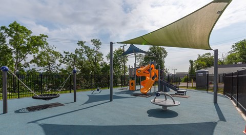 A playground with a swing set and a slide.