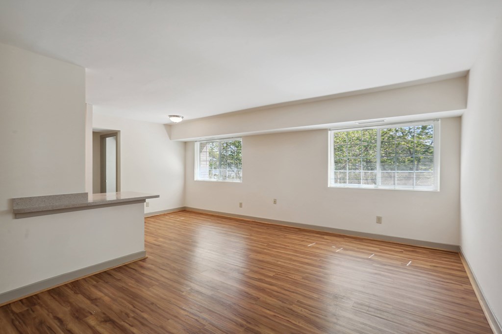 A room with wooden floors and a window.