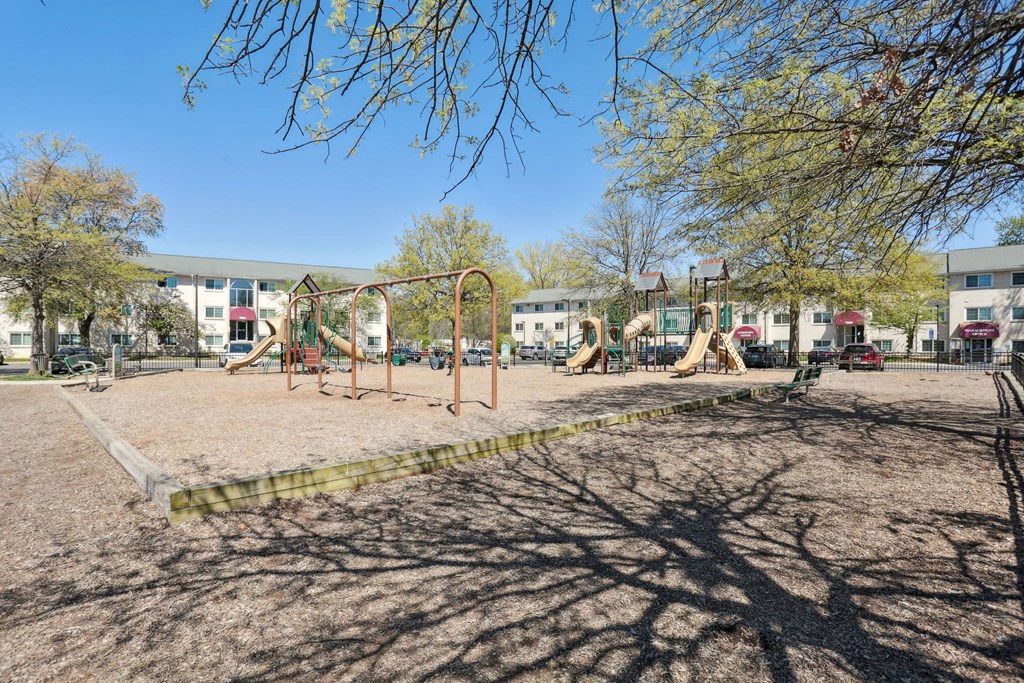 A playground with swings and a slide.