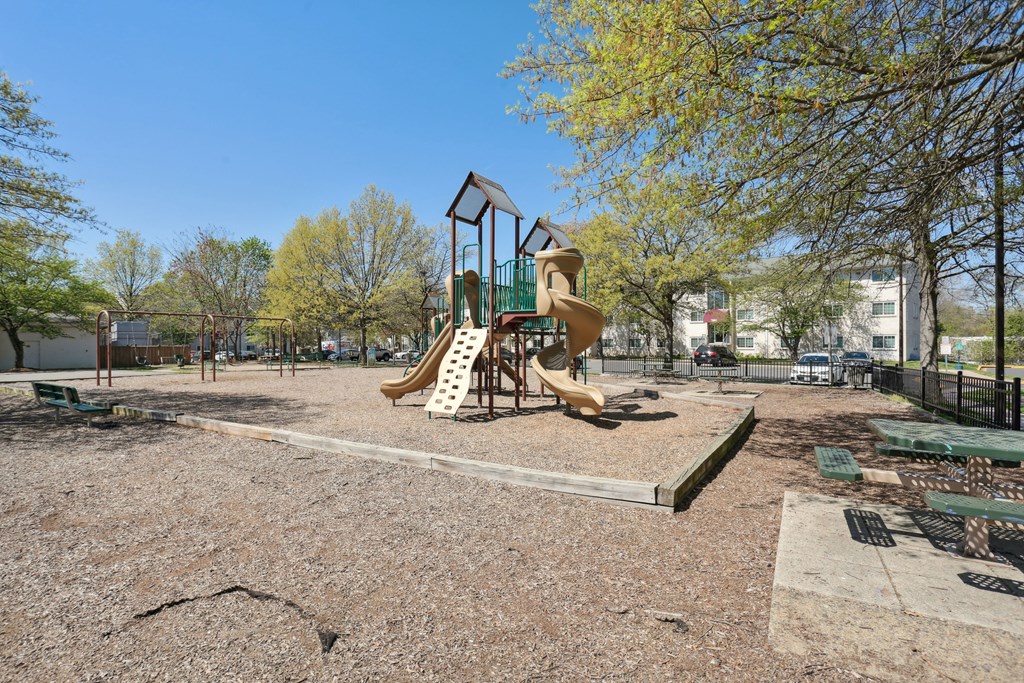 A playground with a slide and a swing set.