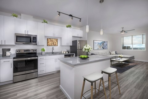 A modern kitchen with white cabinets and a large island.
